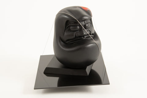 Threshold 4, YOSHIAKI NAKAMURA, 2026Carbon plate, Daruma doll, Wire, Panel, Burlap, Cord, Acrylic, Stitched26.5 × 27.0 × 27.0 cm